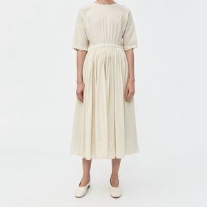 Black Crane pleated dress in cream.